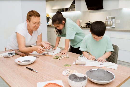 Grandmother and Children Create Clay Crafts Together at Home