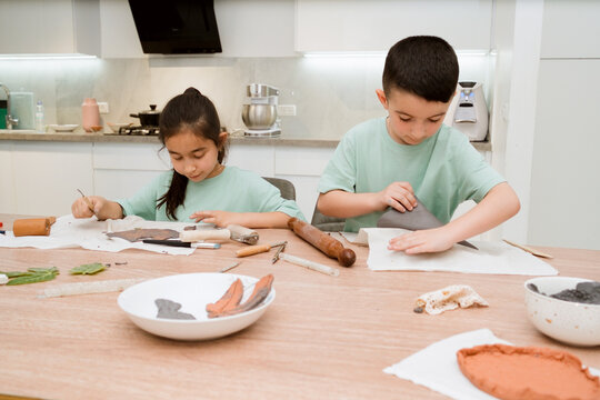 Kids enjoy a clay crafting session with family in a bright kitchen