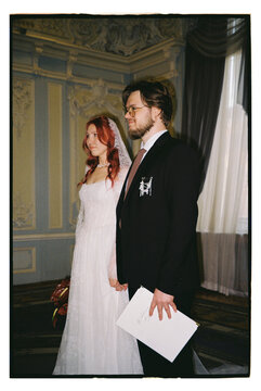 A couple, a man and a woman, during a wedding ceremony.