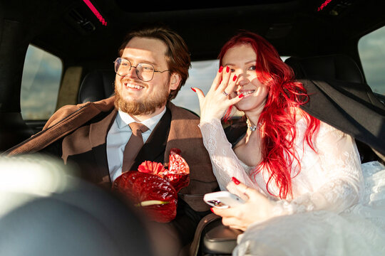 A man and woman in a car happy after getting married