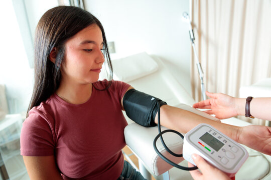 Young patient receiving blood pressure assessment