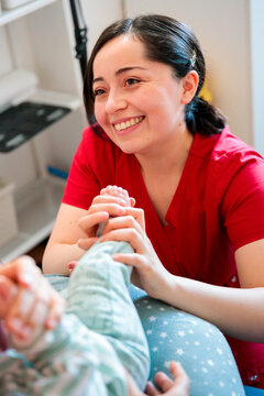 Midwife testing baby's plantar reflex
