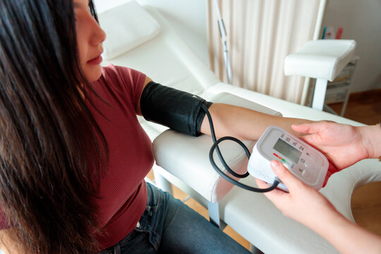 Close-up of digital blood pressure monitor on patient arm