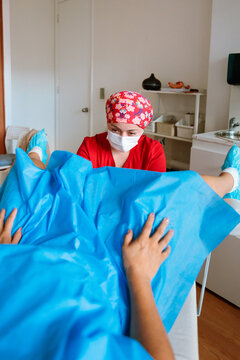 Midwife performing gynecological examination for Pap test