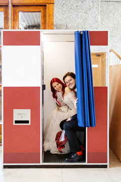 Bride and groom enjoy the moment in a classic photo booth.