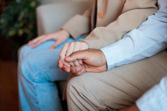Couple holding hands during consultation