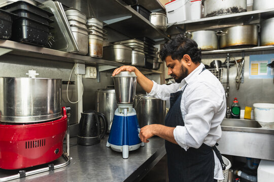Chef using commercial blender in restaurant kitchen