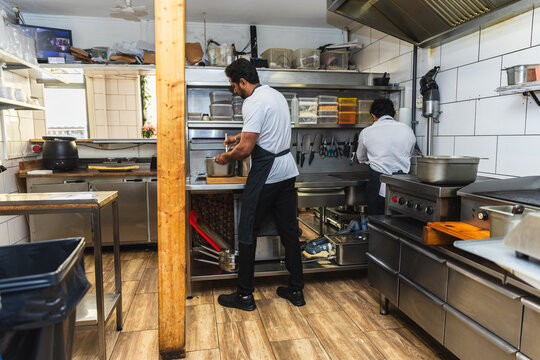 Team of chefs working in Indian restaurant kitchen