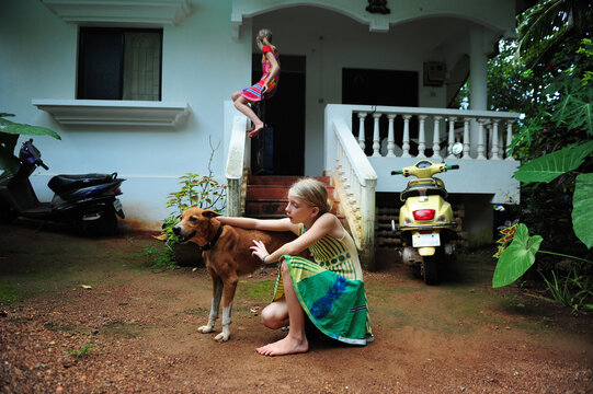 2 girls and their dog playing