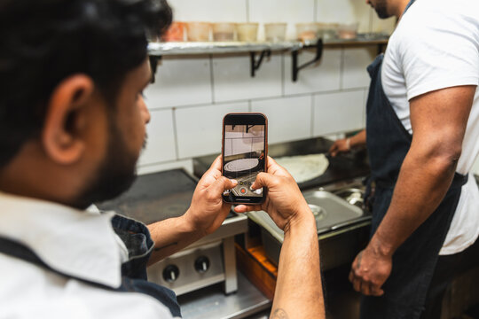 Close up of smartphone recording dosa cooking