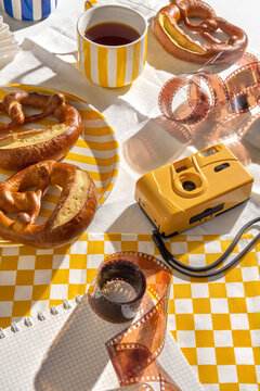 Freshly Baked Pretzels on a Table With a Cup of Tea and a Camera