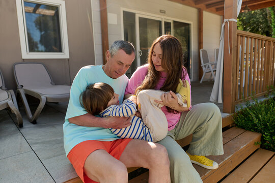 Family cuddling on holiday terrace
