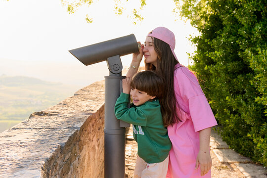 Mother and child using scenic telescope