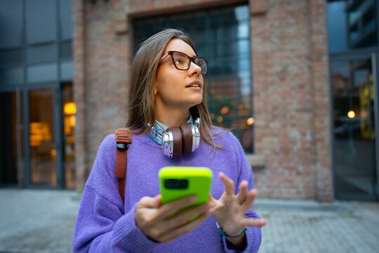 Person using smartphone on city street