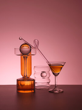 Artistic arrangement of modern glassware with amber liquid