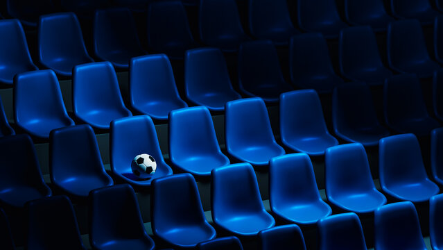 Soccer ball rests on blue stadium seats in an empty arena