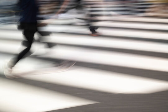 Motion Blurred Feet Crossing City Street