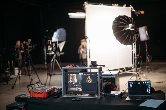 Film set, monitors and modern shooting equipment. Filming crew, lighting devices, monitoring, playback - filming equipment and a team of professionals in filming movies, ads and TV series.