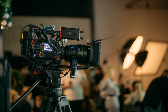 Professional cinema and video camera on the set. Shooting shift, lighting fixtures, shooting equipment and the team. Technique of modern filming and advertising.