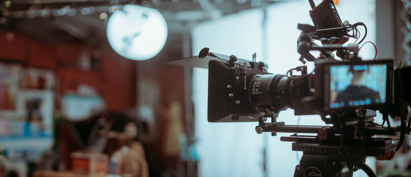 Professional cinema and video camera on the set. Shooting shift, lighting fixtures, shooting equipment and the team.