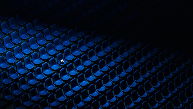 Soccer ball rests on blue stadium seats in an empty arena