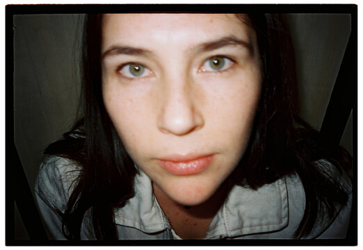 Out of focus Close-up portrait of a young woman looking at camera
