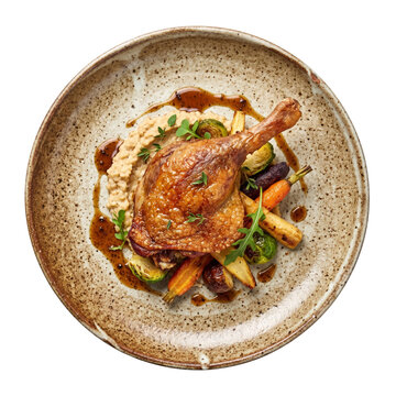 Gourmet roasted duck leg confit with vegetables and puree