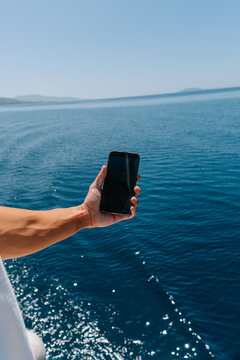 Man taking a photo of the sea scene 
