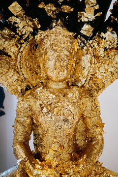 Golden Buddha with detailed design in an indoor setting