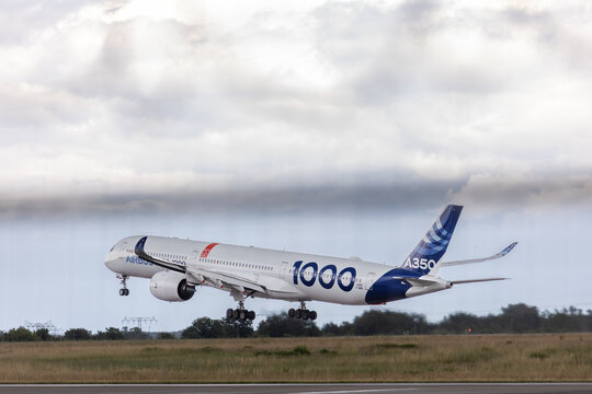Berlin, Germany - June 14 2026. Airbus A350-1000 test aircraft lifts off runway beneath dramatic cloudscape, demonstrating advanced long haul aviation technology and flight performance