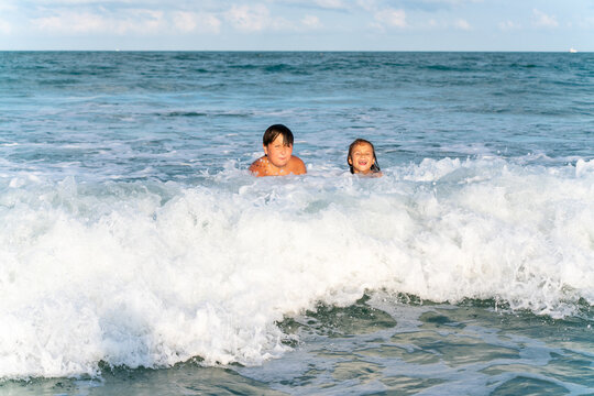 kids playing in waves