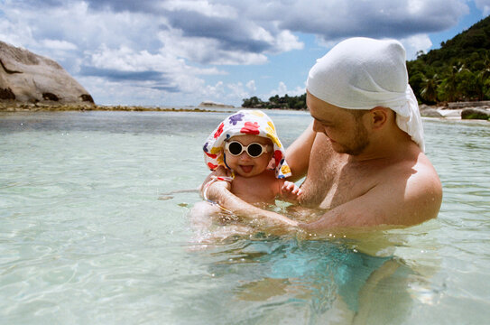 Father and child enjoy water play at the beach