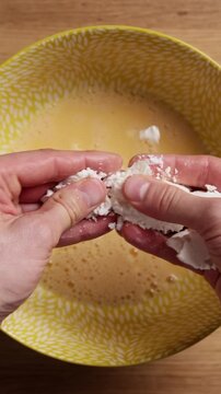 Crumbling Feta Cheese Into Bowl Top View Vertical