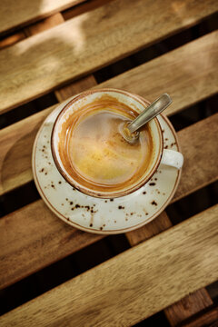 Coffee Cup on a Wooden Table With Shadows in Afternoon Light