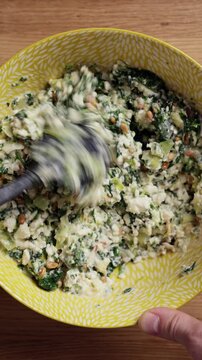 Mixing Spinach Feta Filling In Bowl Top View Vertical