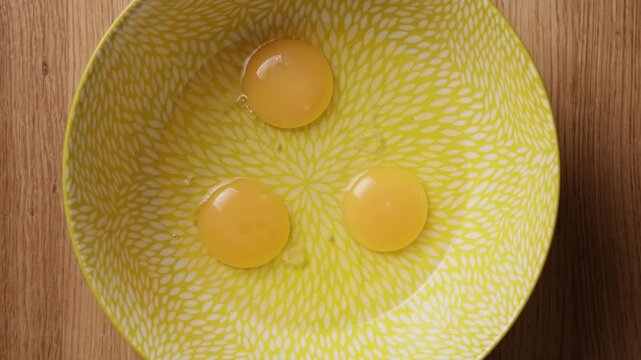 Pouring Eggs Into Bowl Top View