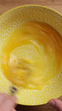 Whisking Eggs In Bowl Top View Vertical