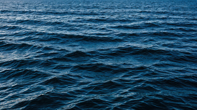 Dark blue ocean water ripples creating a textured marine surface background pattern