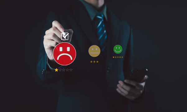 business professional selecting a negative satisfaction rating on a digital interface, featuring a red unhappy face, one-star review, and feedback options representing poor customer experience.