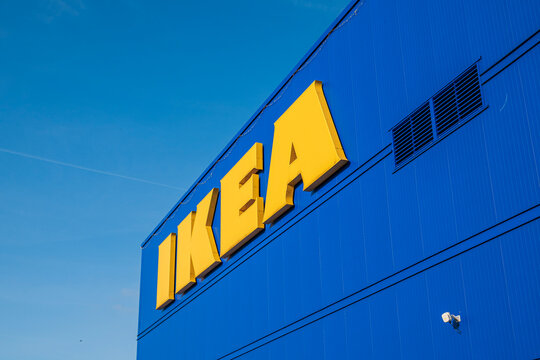 Kaarst, Germany, 10.06.2026 - IKEA brand logo sign with big yellow letters on a bright blue wall, modern commercial retail department store building facade close-up