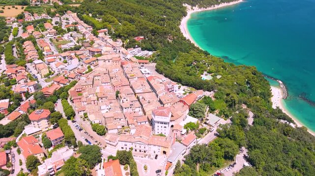 Sirolo Marche Italy 4k drone aerial view of Monte Conero medieval borgo town. Flight over Urbani San Michele beach white cliffs turquoise sea waterfront scenic Riviera del Conero b-roll landscape