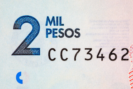 Extreme macro close-up of the 2 Mil Pesos denomination text on a Colombian banknote.Colombian money.
