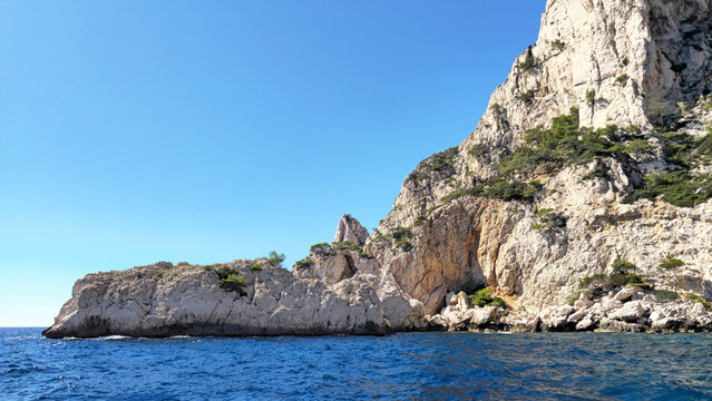 Calanque du Devenson cliffs rising from Mediterranean sea, Provence-Alpes-Cote d'Azur, France, Europe. Calanque du Devenson displaying limestone cliffs and the blue Mediterranean Sea, France.