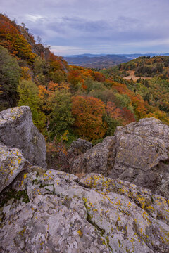 View of autumn forest with colorful foliage and rocky cliffs from Sitno peak in the Stiavnicke Vrchy mountains Ilija, Banska Bystrica Region, Slovakia.