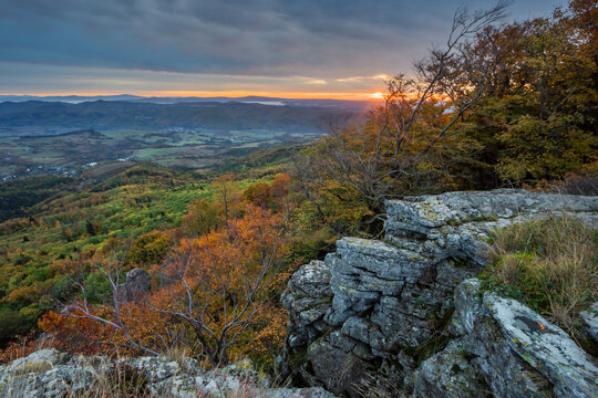 View of sunset over the autumn forest and rocky cliffs of Sitno in the Stiavnicke vrchy mountains near Ilija, Banska Bystrica Region, Slovakia.