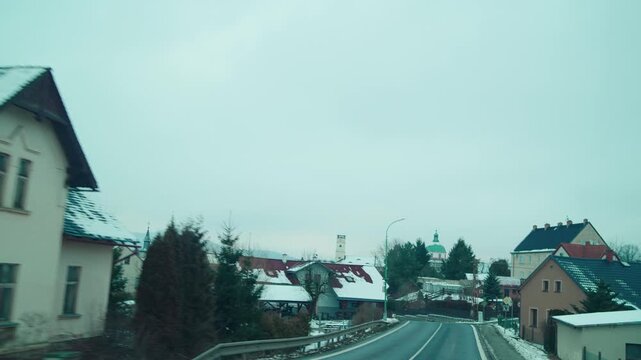 View through windshield while driving from Liberec toward Macha Lake. Road trip in Czech countryside during winter.