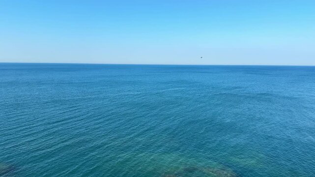 Open sea calm blue waters and clear sunny sky.