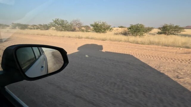 View from the car window of the Namibian savannah, car trip through Africa