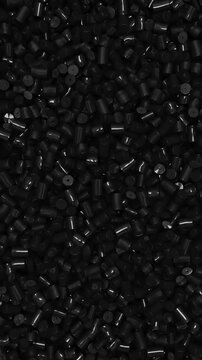 Pan across black polypropylene plastic granules and industrial masterbatch resin pellets, 3D render dynamic Vertical video.