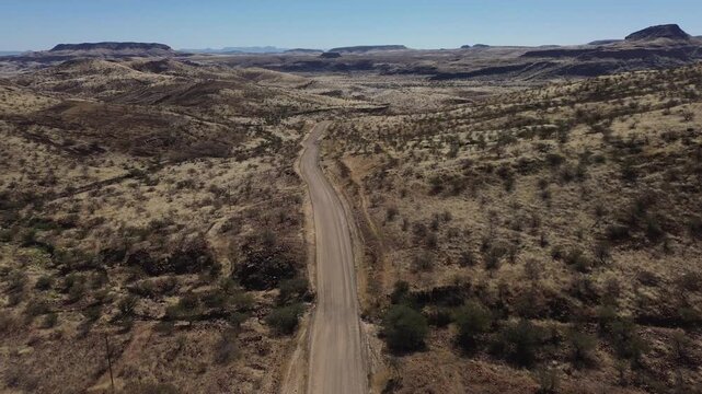 Namibian landscapes, drone flight over the arid African savannah and a deserted gravel road